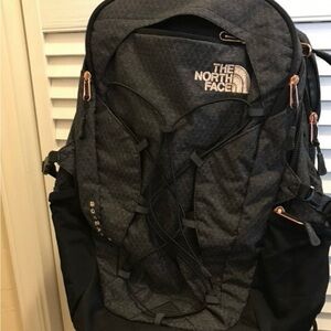 The North Face Charcoal Backpack with a rose gold accent